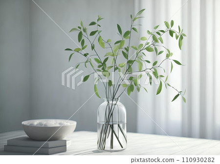 Green Branches in vase on table 110930282