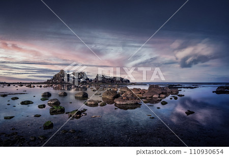 Coastal rocks at sunset seascape 110930654