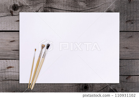 Artist Paint Brush on Blank White Paper. Top View. Drawing Tools in Art Studio. 110931102