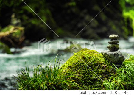 Stone stacking by a river in the forest Zen Japan Stone stacking by a river in the forest Zen Japan 110931461