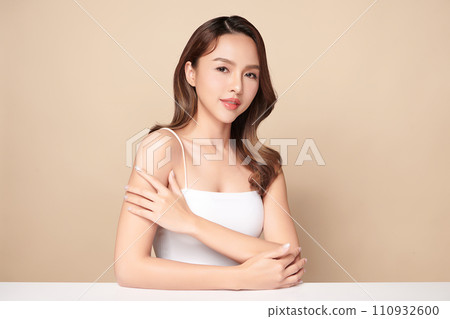 Beautiful young asian woman with clean fresh skin on beige background, Face care, Facial treatment, Cosmetology, beauty and spa, Asian women portrait. 110932600