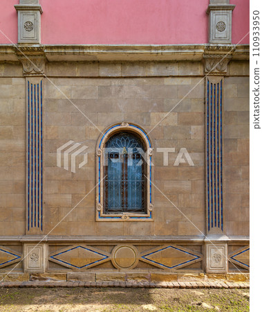 mamluk style arched Window with Wrought Iron Grilles in a brick wall 110933950