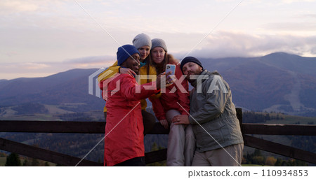 Hiking buddies look at sunset, enjoy the mountains landscape Hiking buddies look at sunset, enjoy the mountains landscape 110934853