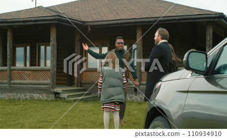 Female real estate agent shows selling property to couple with kids 110934910