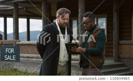 African American real state agent consults Caucasian man African American real state agent consults Caucasian man 110934965