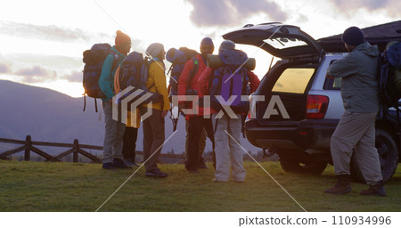 Full shot of diverse tourist friends arrive to rental house on hill Full shot of diverse tourist friends arrive to rental house on hill 110934996