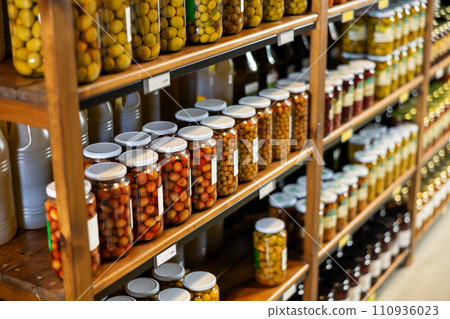 Cans tins of canned green olives are on supermarket shelf. Cans tins of canned green olives are on supermarket shelf. 110936023