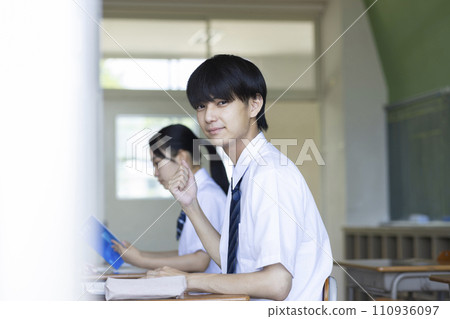 male student studying in the classroom male student studying in the classroom 110936097