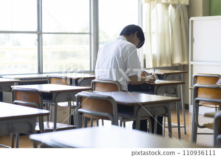 male student studying in the classroom male student studying in the classroom 110936111