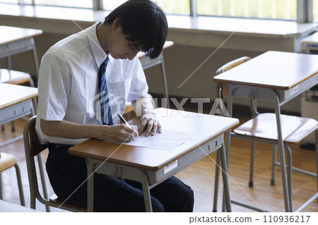 male student studying in the classroom male student studying in the classroom 110936217
