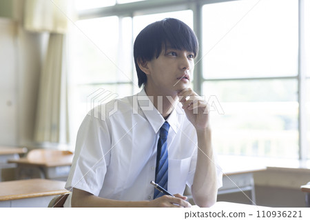 male student studying in the classroom male student studying in the classroom 110936221