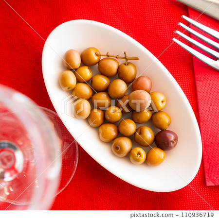 Green olives with pits served in bowl Green olives with pits served in bowl 110936719