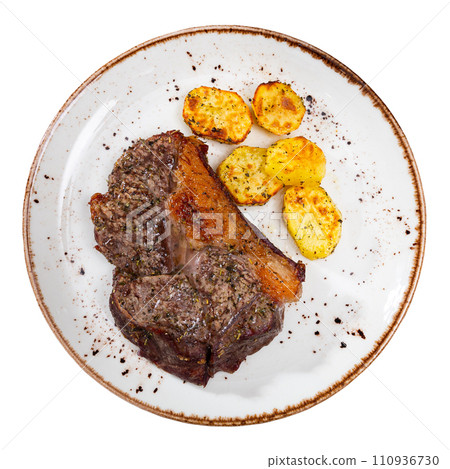 Tasty roasted beef meat with fried potatoes served on table Tasty roasted beef meat with fried potatoes served on table 110936730
