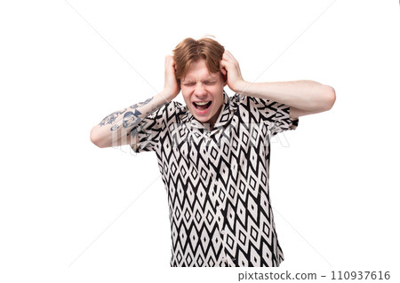 a young European man with golden hair is dressed in a black and white shirt covering his ears and a young European man with golden hair is dressed in a black and white shirt covering his ears and 110937616