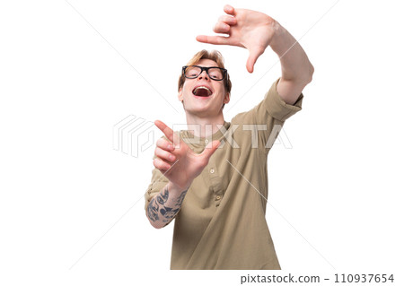 young funny man with red short hair in a brown shirt on a background with copy space young funny man with red short hair in a brown shirt on a background with copy space 110937654