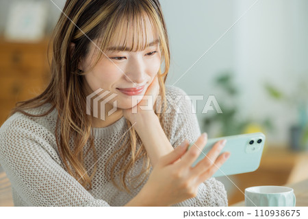 Women's lifestyle Young woman looking at smartphone 110938675