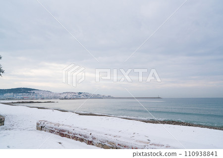 unusual weather on the Adriatic coast, snow on the beach unusual weather on the Adriatic coast, snow on the beach 110938841