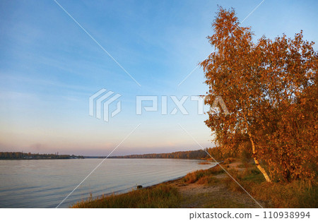 Autumn landscape sunset in the forest by the lake 110938994