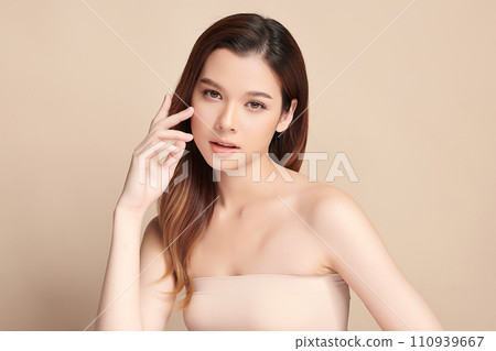 Beautiful young asian woman with clean fresh skin on beige background, Face care, Facial treatment, Cosmetology, beauty and spa, Asian women portrait. 110939667