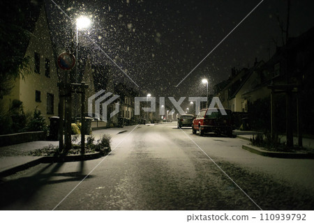 Blurred background. City view, lights, falling snow, night, street, bokeh spots moving cars winter scenery Lantern light Blurred background. City view, lights, falling snow, night, street, bokeh spots moving cars winter scenery Lantern light 110939792