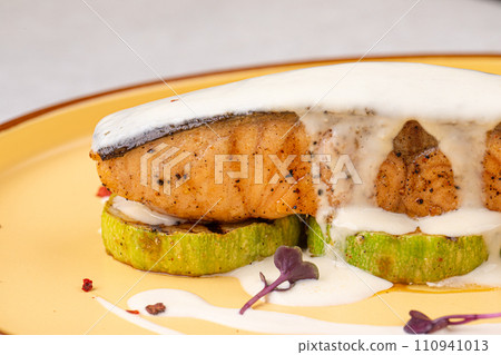 Portion of gourmet salmon steak on zucchini 110941013