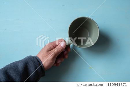 person holding an empty coffee cup 110941871