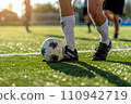 soccer players tackling for the ball 110942719