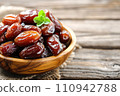 sweet red and black olives on wooden table 110942788