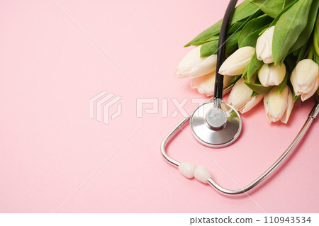 Bunch of white tulips with stethoscope on pink background. National Doctor's day. Happy nurse day. Top view with copy space 110943534