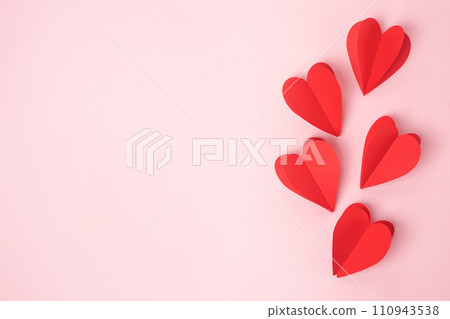 Paper red hearts over the pink pastel background, copy space. Sainte Valentine, mother's day, birthday greeting cards, invitation, celebration concept 110943538