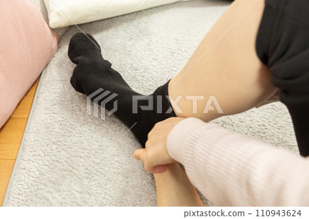 A woman's feet wearing socks 110943624
