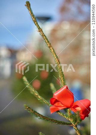 big beautiful Christmas Tree with decorations. New Year and Christmas holiday background. Festive winter city landscape. 110944560