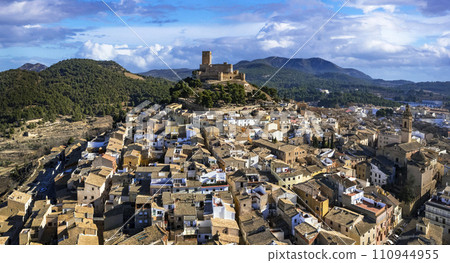 ancient Town Biar in Spain, Sierra de Mariola in the Vinalopo Valley in the province of Alicante . aerial drone panoramic view ancient Town Biar in Spain, Sierra de Mariola in the Vinalopo Valley in the province of Alicante . aerial drone panoramic view 110944955