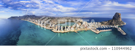 Costa Blanca, Spain. Aerial drone panoramic view of coastal city Calpe with great beaches. Alicante province Costa Blanca, Spain. Aerial drone panoramic view of coastal city Calpe with great beaches. Alicante province 110944962