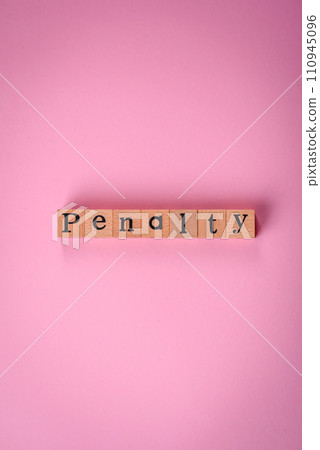 The inscription Penalty made up of wooden cubes on a plain background The inscription Penalty made up of wooden cubes on a plain background 110945096