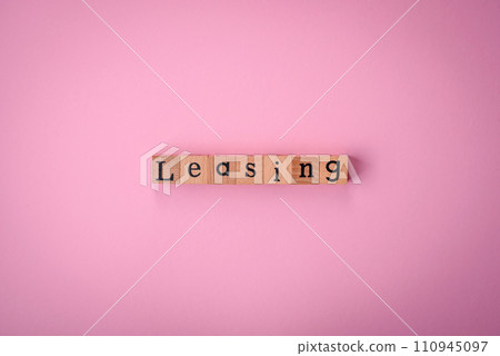 The inscription Leasing made up of wooden cubes on a plain background The inscription Leasing made up of wooden cubes on a plain background 110945097