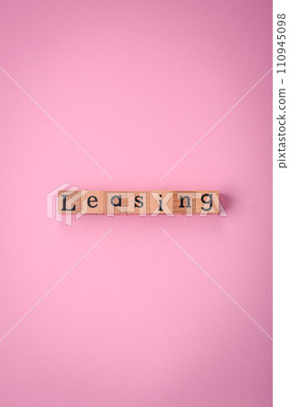 The inscription Leasing made up of wooden cubes on a plain background The inscription Leasing made up of wooden cubes on a plain background 110945098
