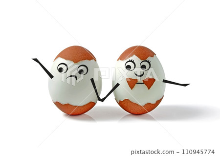 Two chicken eggs with shells and drawn faces and hands isolated on a white background. Comic decorated pair of eggs for a wedding in the form of a boy and a girl Two chicken eggs with shells and drawn faces and hands isolated on a white background. Comic decorated pair of eggs for a wedding in the form of a boy and a girl 110945774