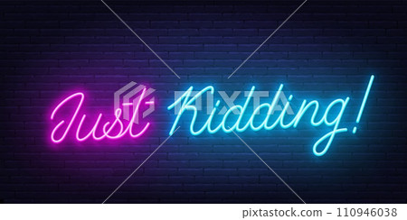 Just Kidding neon lettering on brick wall background 110946038