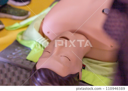 Close-up view of a CPR training mannequin used for demonstrating lifesaving techniques in a first aid course 110946389