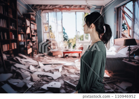 A woman is at a loss after her house collapses due to an earthquake. A woman is at a loss after her house collapses due to an earthquake. 110946952