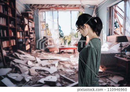 A woman is at a loss after her house collapses due to an earthquake. A woman is at a loss after her house collapses due to an earthquake. 110946960