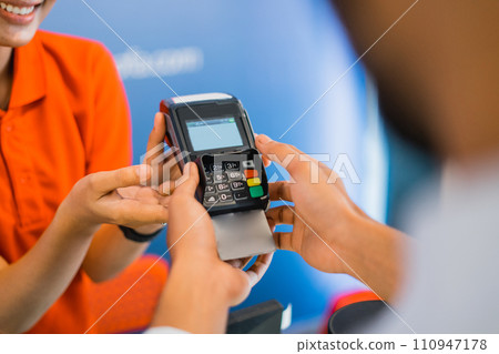 close up of a hand using an EDC tool for payment 110947178
