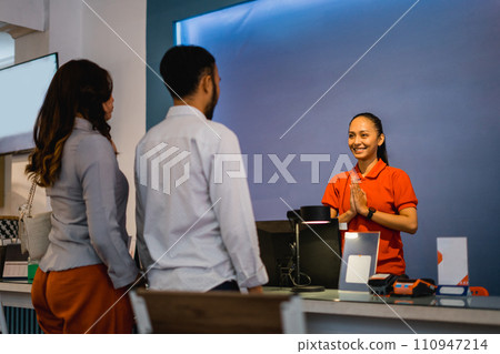 a couple comes to the shop greeted by a shop assistant a couple comes to the shop greeted by a shop assistant 110947214