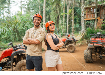 asian couple with safety equipment standing with hands crossed asian couple with safety equipment standing with hands crossed 110947262