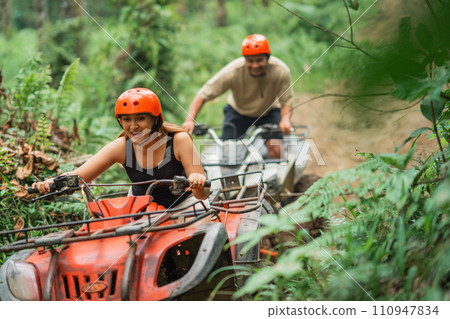 happy asian couple enjoy their atv tracking during the holiday time happy asian couple enjoy their atv tracking during the holiday time 110947834