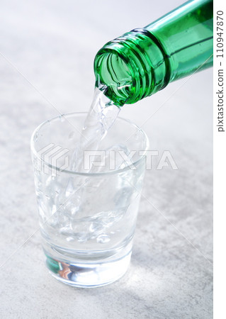 Pour Korean soju into a glass 110947870