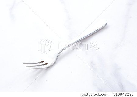 Forks on a white marble background 110948285