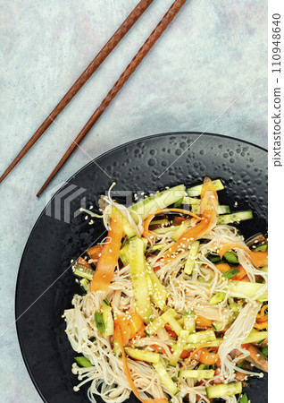 Salad with enoki mushrooms. 110948640