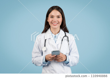 happy woman doctor in white coat with cellphone happy woman doctor in white coat with cellphone 110948866